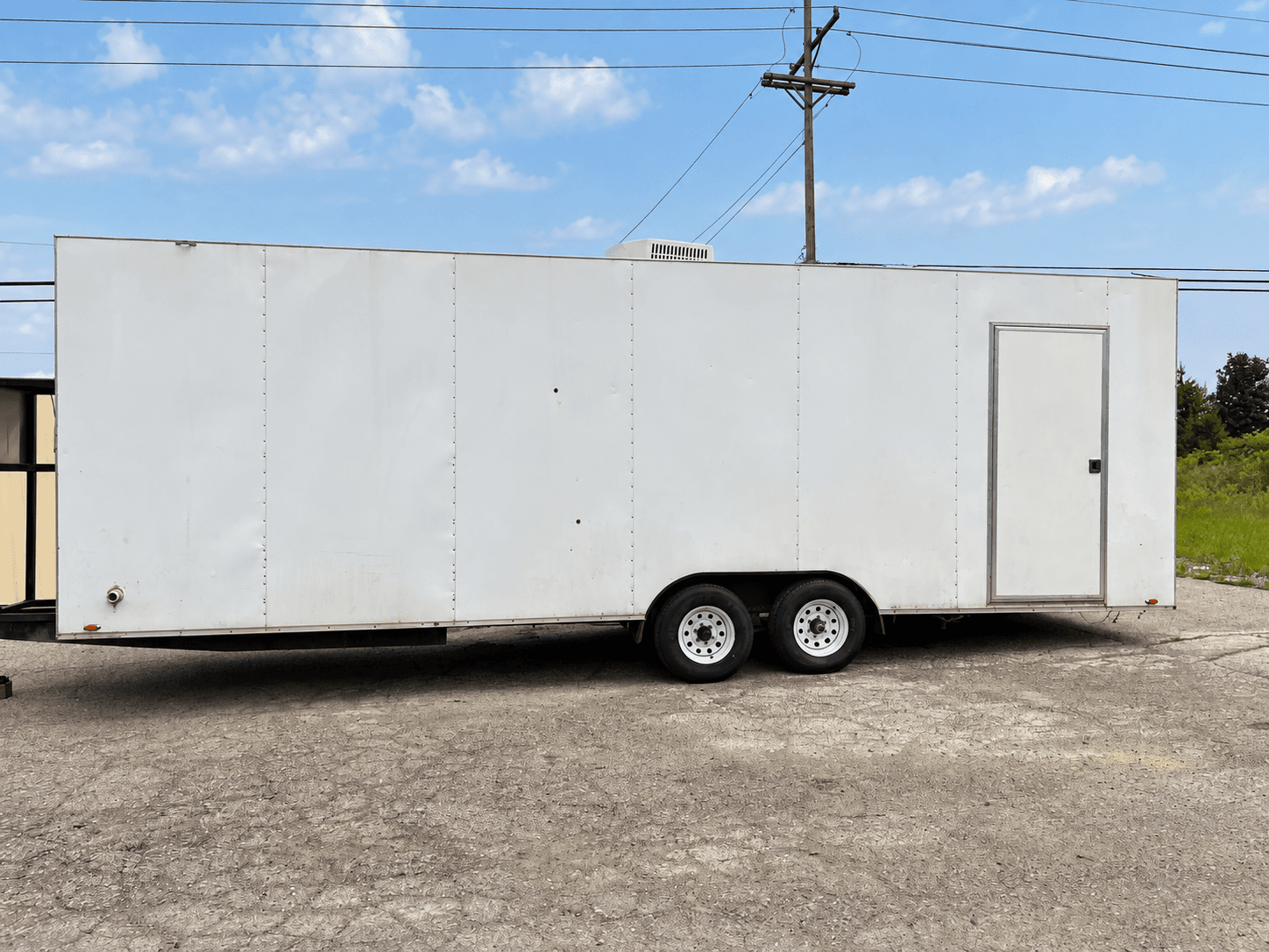 Plain white dishwashing trailer exterior with side access door