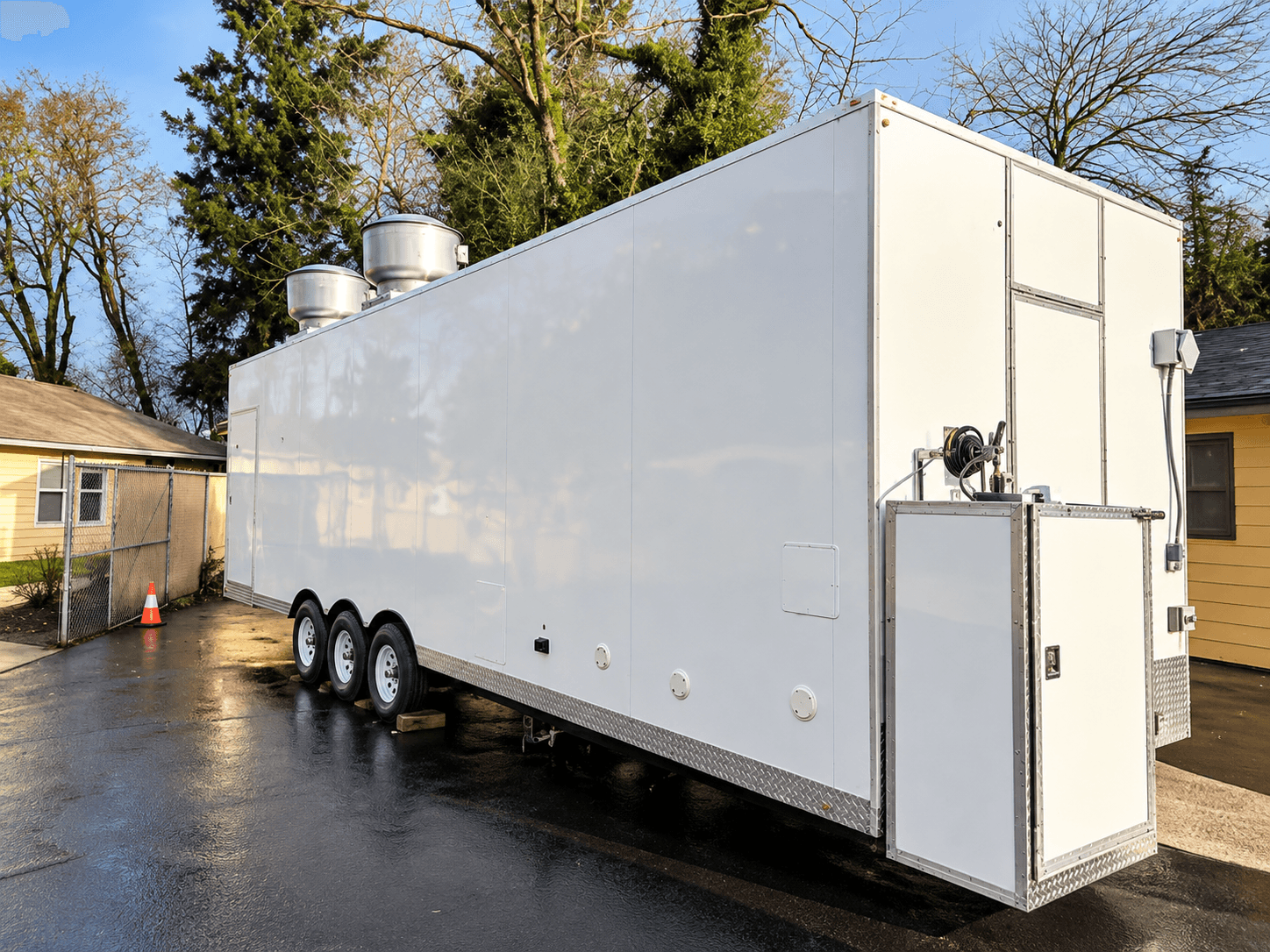 White mobile kitchen trailer exterior with rooftop ventilation fans